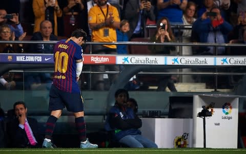 Lionel Messi walks off with his arm bandaged - Credit: getty images
