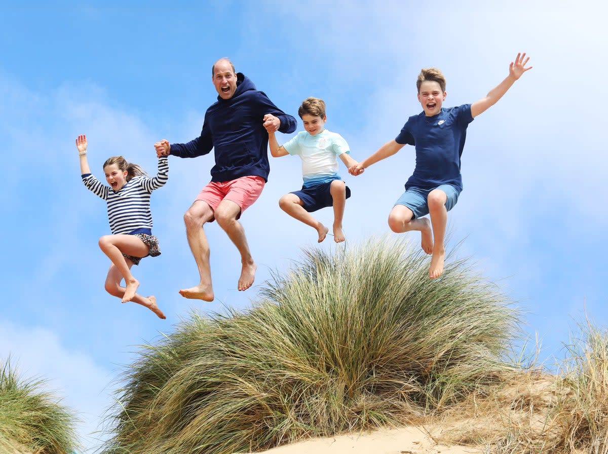 A photo of Prince William at the beach with his children, released on his 42nd birthday (Kensington Palace)