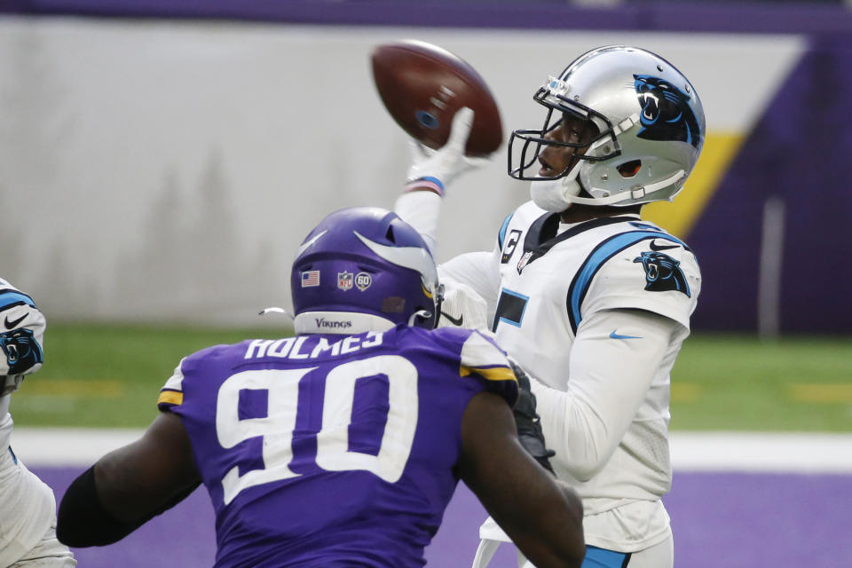 Carolina Panthers quarterback Teddy Bridgewater throws a pass over Minnesota Vikings defensive end Jalyn Holmes (90) during the second half of an NFL football game, Sunday, Nov. 29, 2020, in Minneapolis. The Vikings won 28-27. (AP Photo/Bruce Kluckhohn)