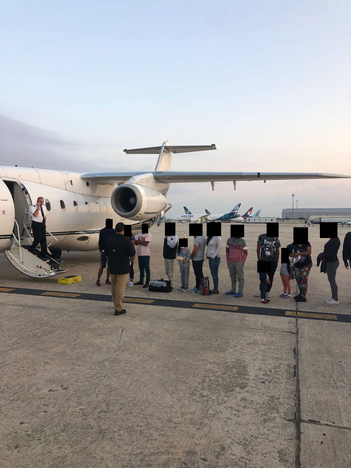 Migrants, their faces obscured, outside the plane that ferried them from Texas to Martha’s Vineyard, Massachusetts. Florida taxpayers paid for the charter.