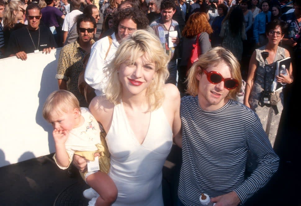 Kurt Cobain (1967-1994) of Nirvana poses with his wife Courtney Love of Hole and child Frances Bean Cobain as they attend the 10th Annual MTV Video Music Awards on September 2, 1993 at the Universal Amphitheatre in Universal City, California.