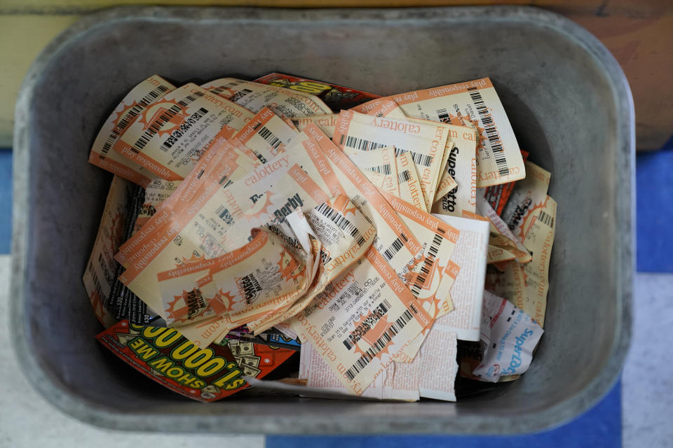 Powerball ticket receipts are seen in the garbage, Wednesday, July 19, 2023, in Hawthorne, Calif. With lottery jackpots for Powerball and Mega Millions cumulatively approaching $2 billion for this week's drawings, millions of people across the country will be lining up at convenience store, grocery and gas station counters hoping to hit it big. (AP Photo/Ryan Sun)
