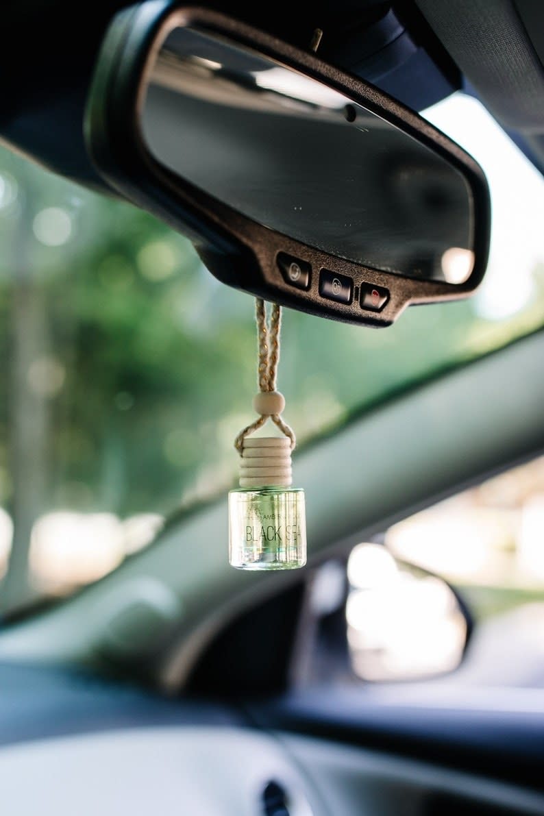 the car diffuser hanging from the rearview mirror of a car