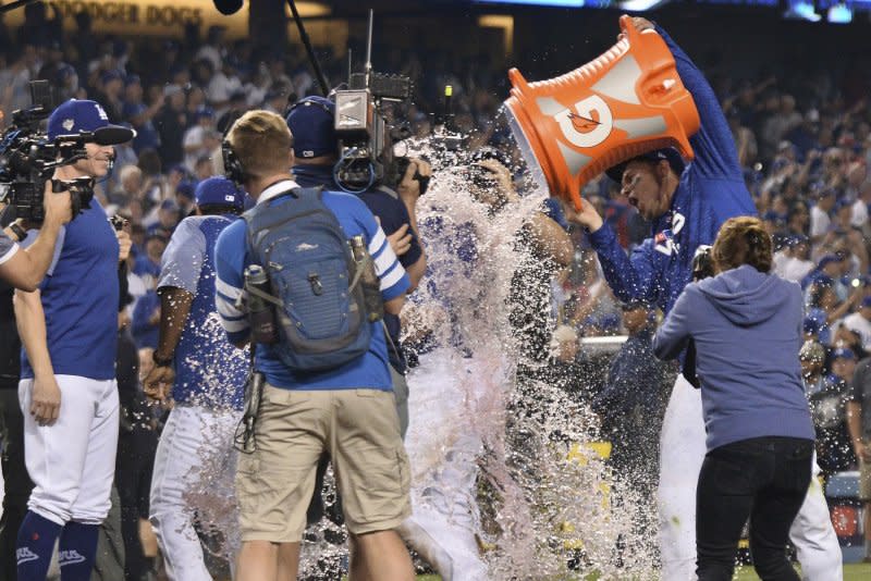 Los Angeles Dodgers first baseman Max Muncy (C) gets doused with Gatorade after hitting a walk-off solo home run during the 18th inning against the Boston Red Sox in Game 3 of the MLB 2018 World Series at Dodger Stadium in Los Angeles on October 26, 2018. It was the longest World Series game in terms of time in history. File Photo by Jim Ruymen/UPI