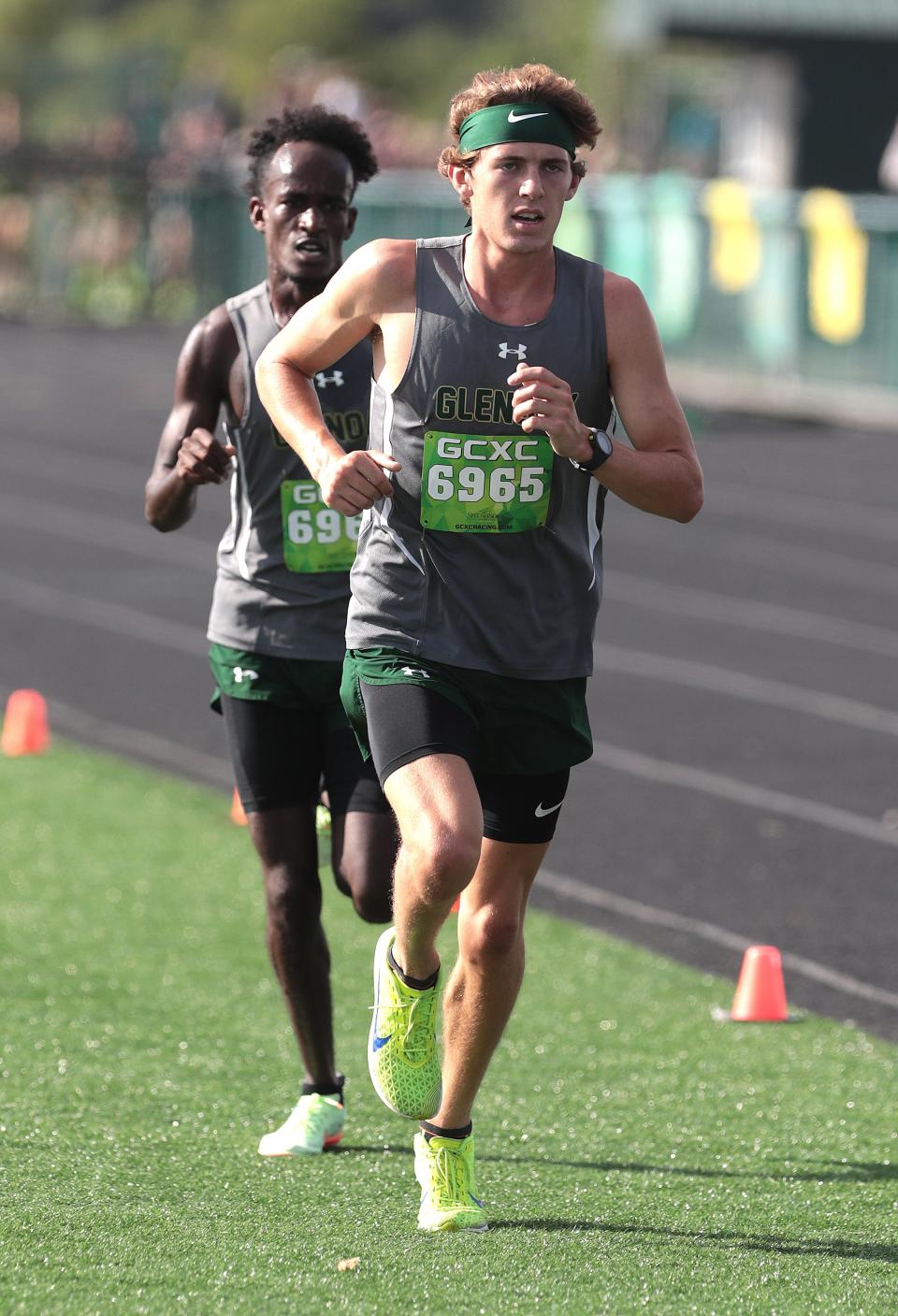 GlenOak's Tommy Rice ,right, finished first followed by teammate Tes Young in second place at the GlenOak Golden Eagle Invitational cross country meet Saturday, August 27, 2022.