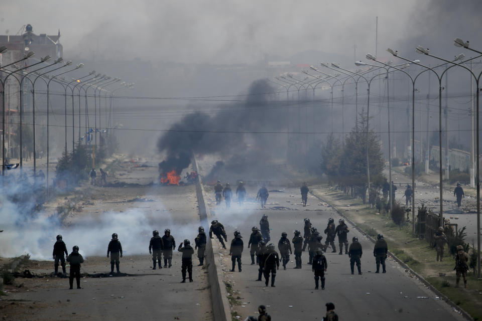 Security forces guard the road leading to a gas plant in El Alto, on the outskirts of La Paz, Bolivia, as supporters of former President Evo Morales set up barricades, Tuesday, Nov. 19, 2019. Morales' backers have taken to the streets asking for his returns since he resigned on Nov. 10 under pressure from the military after weeks of protests against him over a disputed election he claim to have won. (AP Photo/Natacha Pisarenko)