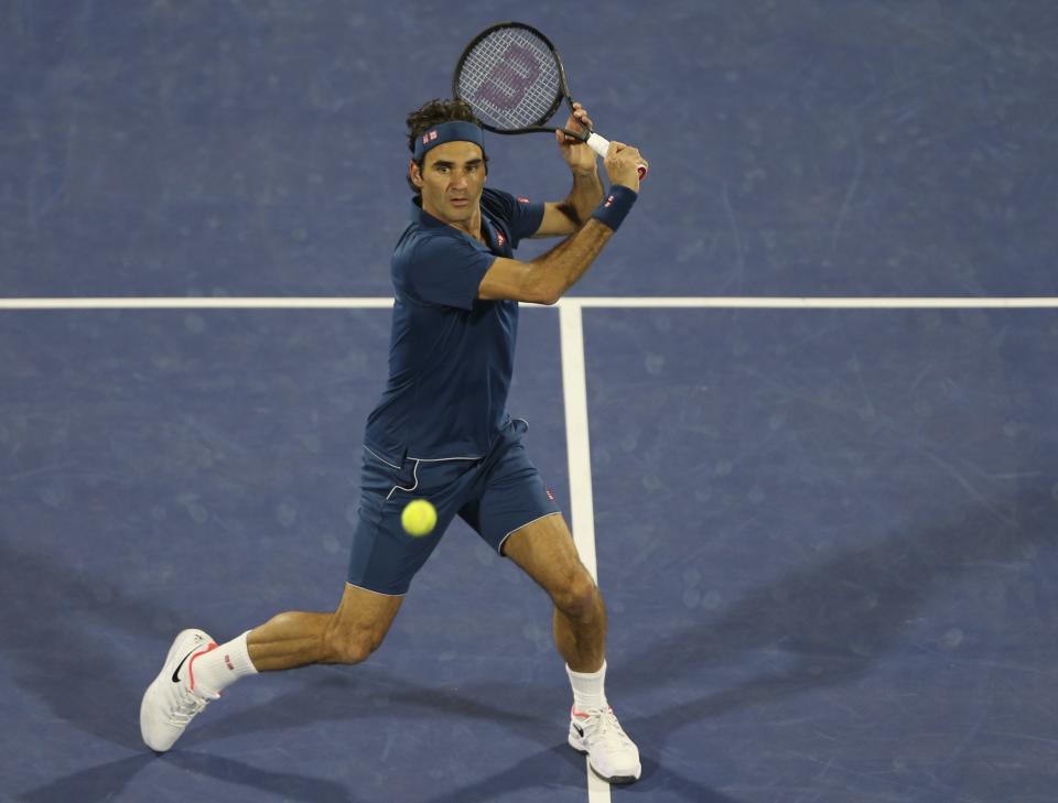 Roger Federer of Switzerland returns the ball to Stefanos Tsitsipas of Greece during their final match at the Dubai Duty Free Tennis Championship, in Dubai, United Arab Emirates, Saturday, March 2, 2019. (AP Photo/Kamran Jebreili)