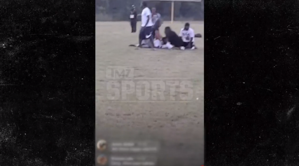 Attendees at a youth football game in Texas can be seen tending to a person who appears to have been hurt after gunshots were fired at a Saturday night game outside of Dallas (TMZ Sports/video screengrab)