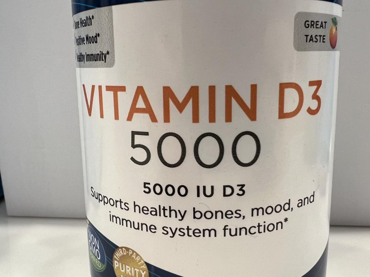 Close-up of container of a bottle containing Vitamin D supplements