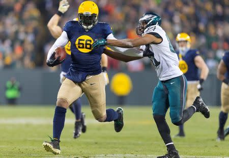 Nov 16, 2014; Green Bay, WI, USA; Green Bay Packers linebacker Julius Peppers (56) returns an interception for a touchdown as Philadelphia Eagles wide receiver Jordan Matthews (81) tries to make the tackle during the third quarter at Lambeau Field. Green Bay won 53-20. Mandatory Credit: Jeff Hanisch-USA TODAY Sport