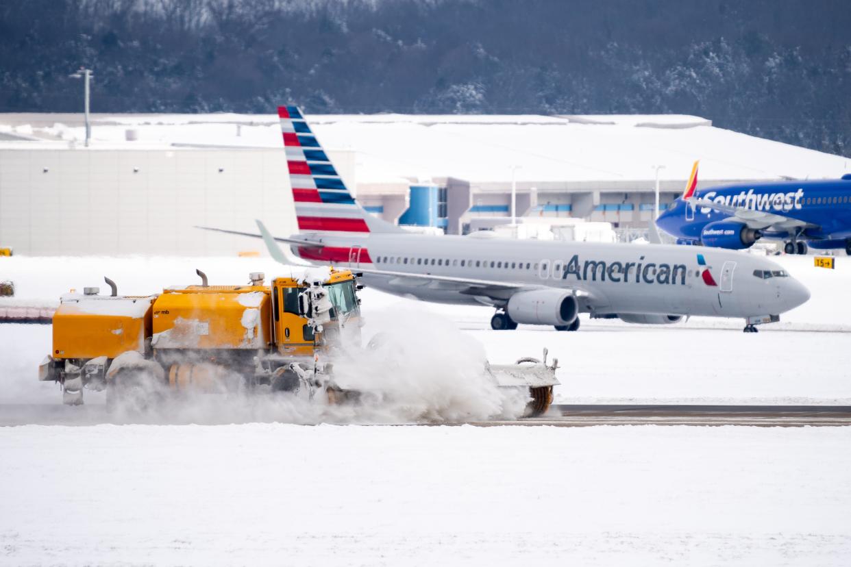 Crews works on clearing snow at Nashville International Airport in Nashville, Tenn., Tuesday, Jan. 16, 2024. Over 100 flights were delayed or canceled Monday due to the winter weather.