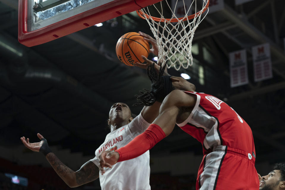Maryland's Julian Reese, left, blocks the shot of Ohio State's player Eugene Brown, right, during the first half of an NCAA college basketball game, Sunday, Jan. 8, 2023, in College Park, Md. (AP Photo/Jose Luis Magana)