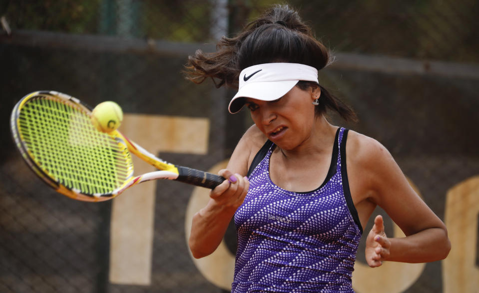 Transgender tennis player Mia Fedra returns the ball during a training session in Buenos Aires, Argentina, Friday, Dec. 4, 2020. There are no official figures on the trans community in Argentina since it was not included in the last 2010 census. (AP Photo/Natacha Pisarenko)