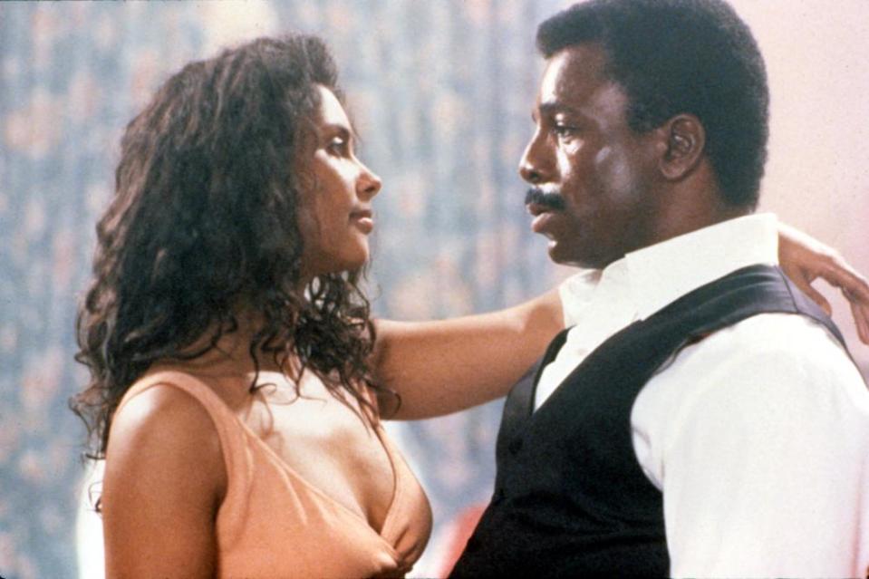 Carl Weathers being held by woman