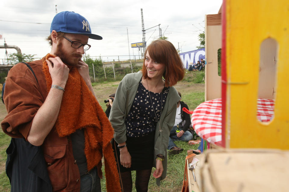 BERLIN, GERMANY - JULY 21: Attendees look at items from a "swap box," where visitors can take items in exchange for leaving others, at the second annual Hipster Olympics on July 21, 2012 in Berlin, Germany. With events such as the "Horn-Rimmed Glasses Throw," "Skinny Jeans Tug-O-War," "Vinyl Record Spinning Contest" and "Cloth Tote Sack Race," the Hipster Olympics both mocks and celebrates the Hipster subculture, which some critics claim could never be accurately defined and others that it never existed in the first place. The imprecise nature of determining what makes one a member means that the symptomatic elements of adherants to the group vary in each country, but the archetype of the version in Berlin, one of the more popular locations for those following its lifestyle, along with London and Brooklyn, includes a penchant for canvas tote bags, the carbonated yerba mate drink Club Mate, analogue film cameras, asymmetrical haircuts, 80s neon fashion, and, allegedly, a heavy dose of irony. To some in Berlin, members of the hipster "movement" have replaced a former unwanted identity in gentrifying neighborhoods, the Yuppie, for targets of criticism, as landlords raise rents in the areas to which they relocate, particularly the up-and-coming neighborhood of Neukoelln. (Photo by Adam Berry/Getty Images)