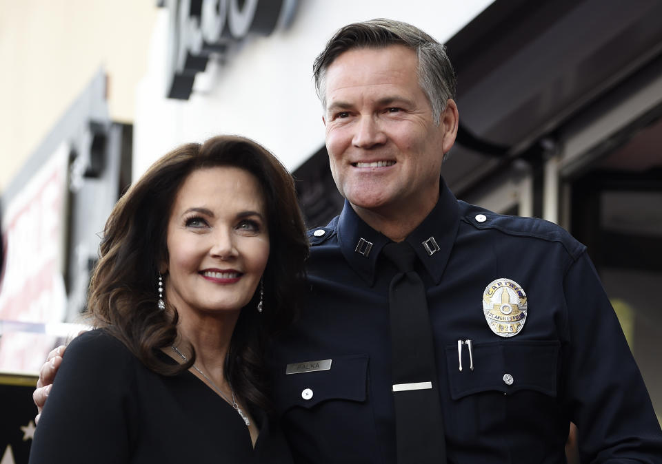 FILE - Actor Lynda Carter, left, poses with former Los Angeles Police Department Captain Cory Palka during a ceremony to award her a star on the Hollywood Walk of Fame, Tuesday, April 3, 2018, in Los Angeles. Palka's ties to Hollywood are under scrutiny after prosecutors say he leaked a sexual assault victim's confidential police report to CBS and its former leader Les Moonves. (AP Photo/Chris Pizzello, File)