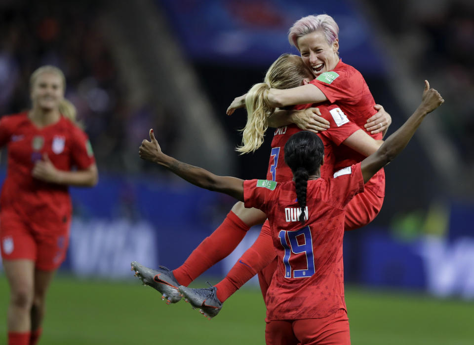 FILE - United States' scorer Samantha Mewis lifts her teammate Megan Rapinoe as she celebrates her side's 4rth goal during the Women's World Cup Group F soccer match between United States and Thailand at the Stade Auguste-Delaune in Reims, France, June 11, 2019. The Thailand women's soccer team endured the biggest-ever loss at a women's soccer World Cup, in June 2019, a 13-0 trouncing by the United States which cast an unwelcome spotlight on the state of the sport in the South East Asian nation. Now a refurbished Thailand team under a new head coach and with the youngest playing group in its history has played Cameroon in an inter-continental playoff match in New Zealand, hoping to qualify again for a World Cup and move beyond the shadow of that defeat. (AP Photo/Alessandra Tarantino, File)