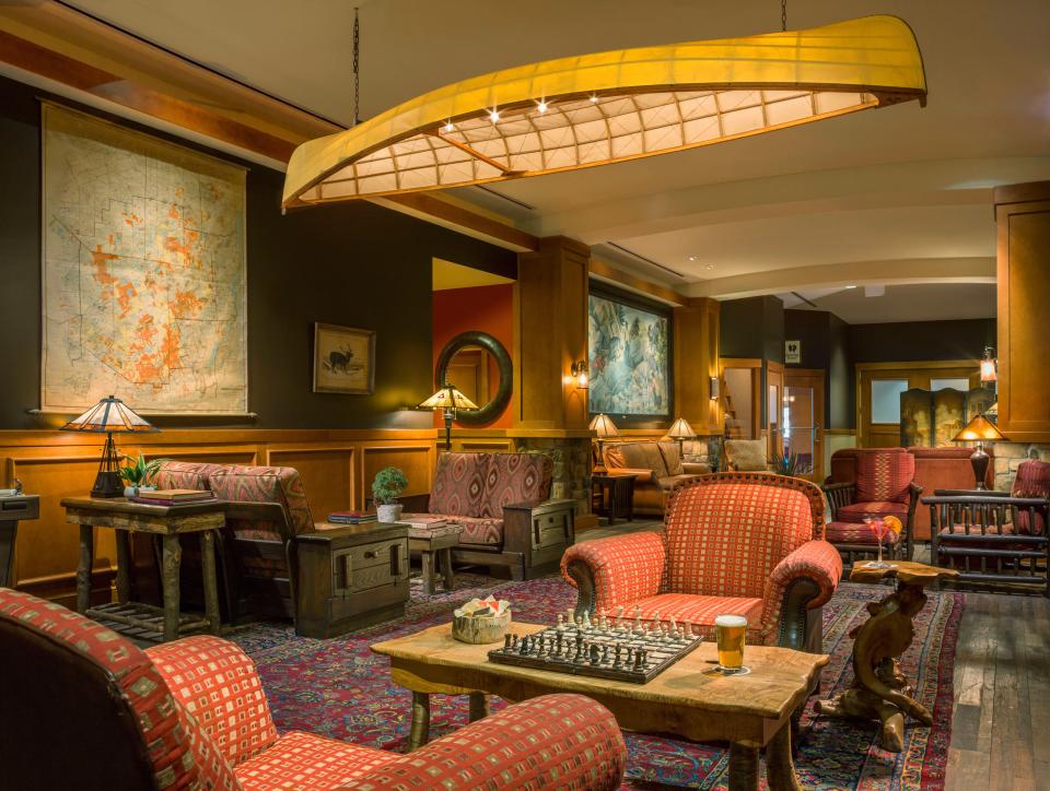 At High Peaks Resort in New York's Adirondacks, roughing it means enjoying a glass of bubbly happily handed to guests upon arrival in the expansive lobby decorated with gorgeous vintage canoes.