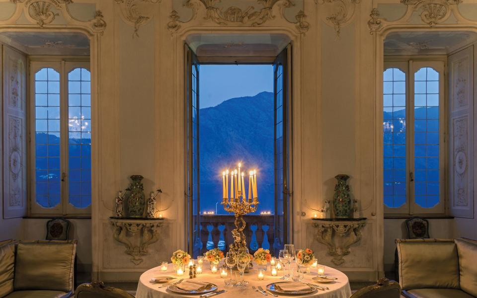 A romantic dinner in the dining room of Grand Hotel Tremezzo's Villa Sola Cabiati on Lake Como
