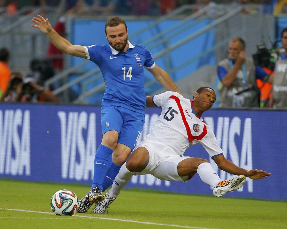 Greece's Dimitris Salpingidis (L) fights for the ball with Costa Rica's Junior Diaz during their 2014 World Cup round of 16 game at the Pernambuco arena in Recife June 29, 2014. REUTERS/Brian Snyder