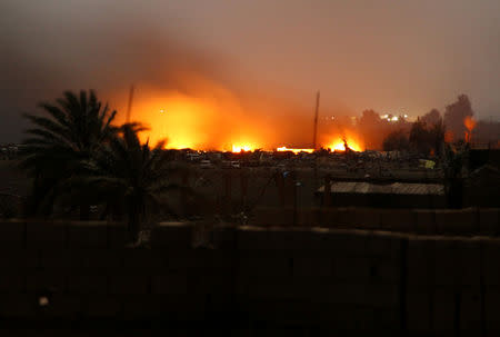 Fire is seen during fighting in the Islamic State's final enclave, in the village of Baghouz, Deir Al Zor province, Syria March 17, 2019. REUTERS/Stringer