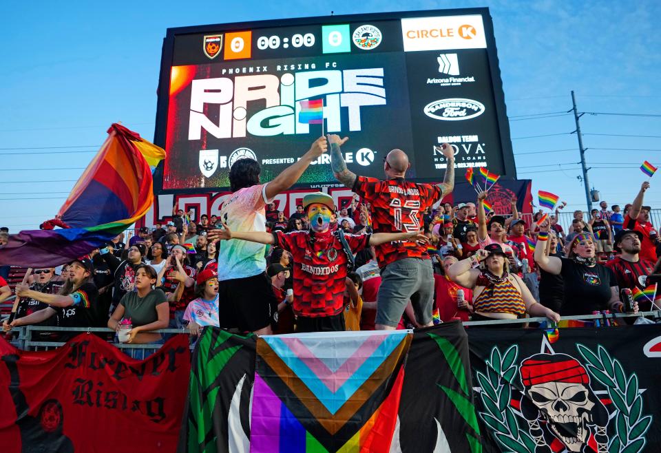 Fans pump up the crowd prior to a game on Pride Night at Phoenix Rising Stadium on June 10, 2023.