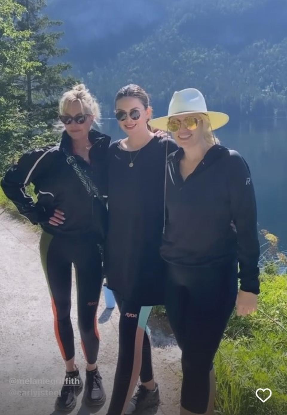 Rebel pictured with Melanie Griffiths (T) and Entertainment Tonight host Carly Steel (centre) at the VivaMayr at the resort (Instagram/Rebel Wilson)