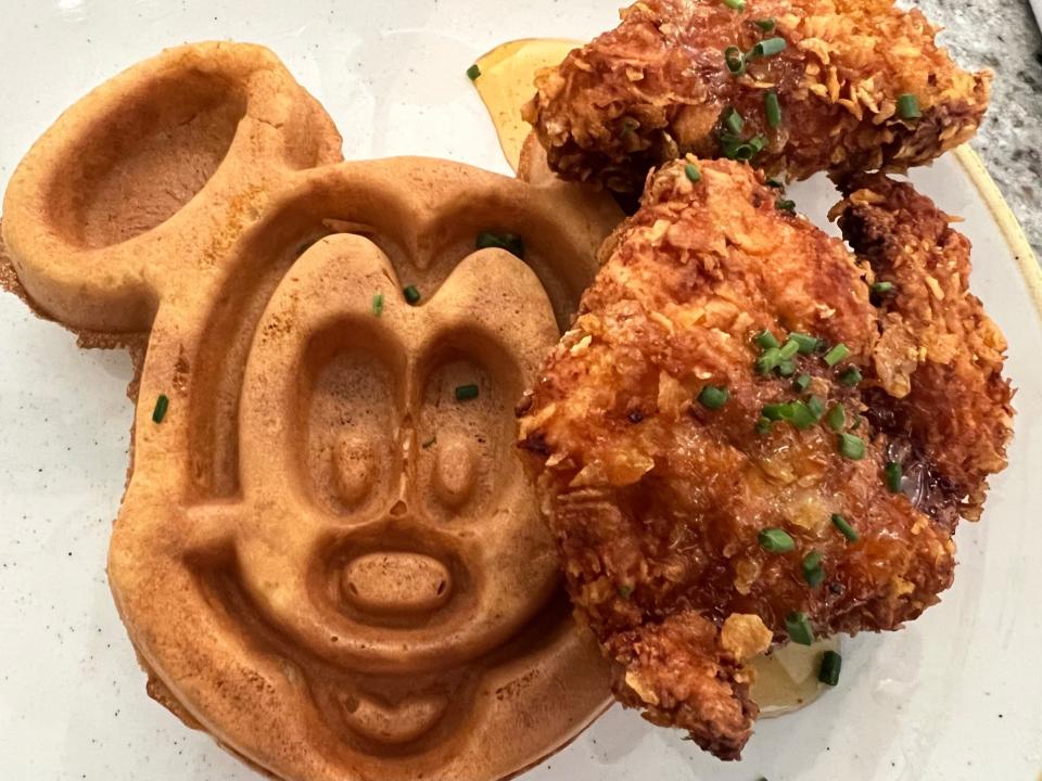 Hand-breaded buttermilk fried chicken is served with a Mickey-shaped malted waffle at Grand Floridian Cafe.