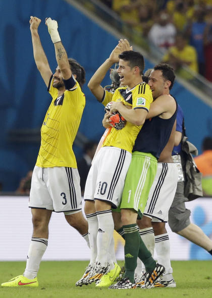 James Rodriguez (10) is lifted off his feat by his teammates following Colombia&#39;s 2-0 victory over Uruguay.  (AP)