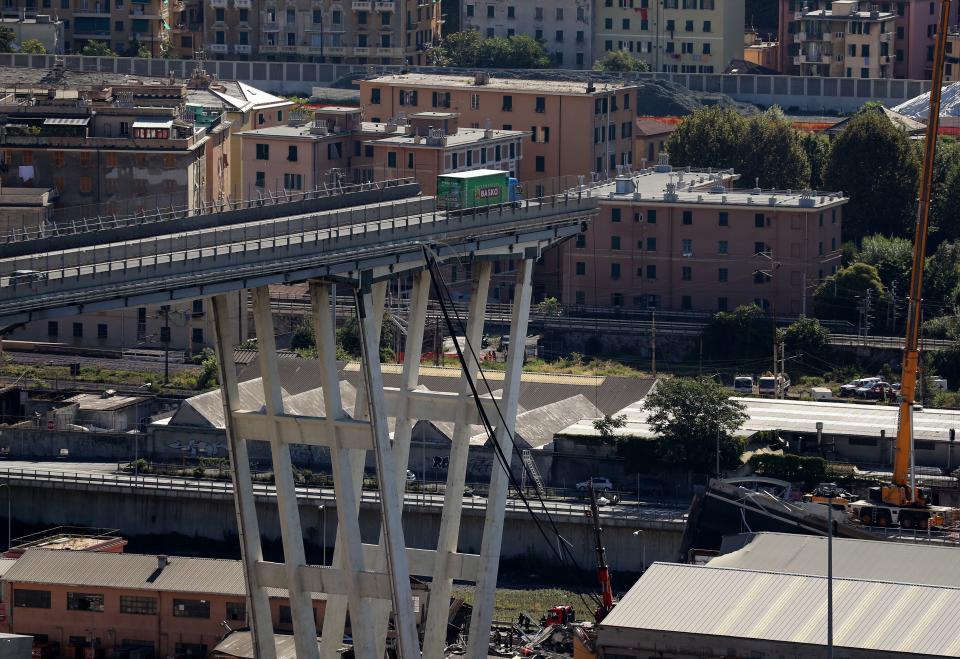 A lorry abandoned on the remaining section of the 50-year-old bridge that collapsed on Tuesday (Getty)