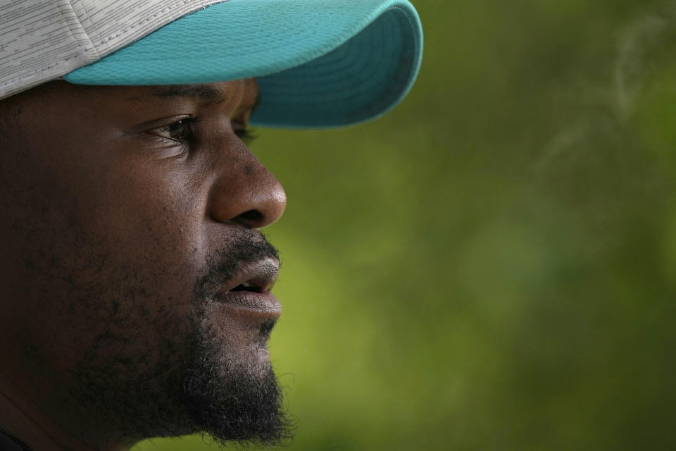 Brian Flores Head Coach of the Miami Dolphins speaks to the press during a practice and media availability by the Miami Dolphins In Ware, England, Friday, Oct. 15, 2021. The Dolphins play the Jaguars in a regular season NFL game on Sunday at Tottenham Hotspurs White Hart Lane stadium in London. (AP Photo/Alastair Grant)