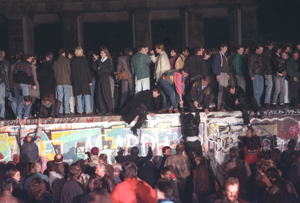 West Berlin citizens continue their vigil atop the Berlin Wall in front of the Brandenburg Gate, Nov. 10, 1989. Thousands of people rallied on the dividing border. (Photo: Reuters)