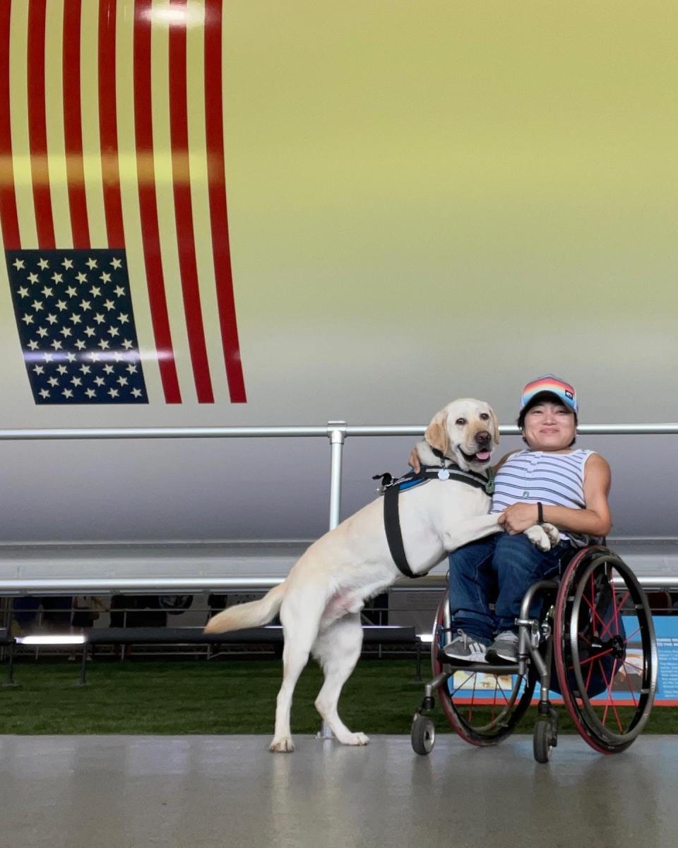 Mia Ives-Rublee and her service dog Zini.