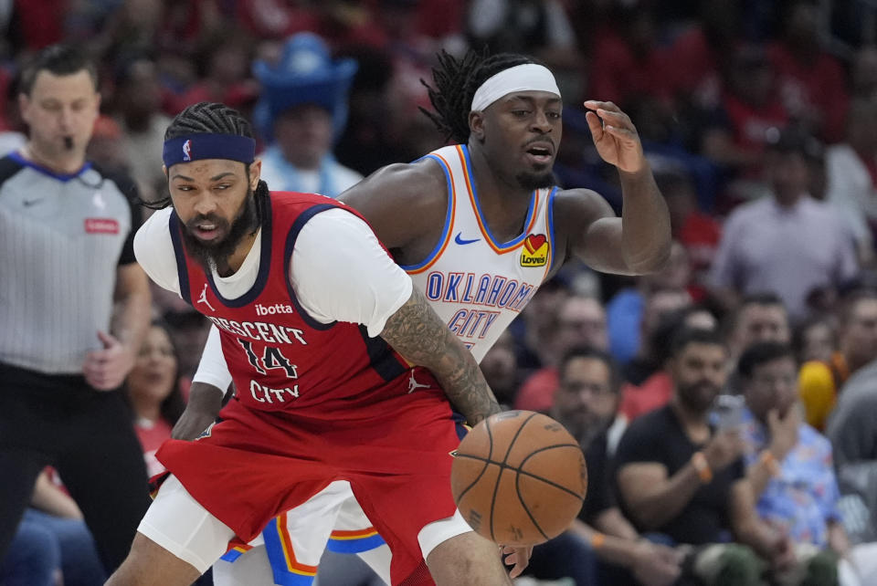 New Orleans Pelicans forward Brandon Ingram (14) chases a ball that was knocked away by Oklahoma City Thunder guard Luguentz Dort in the second half of Game 3 of an NBA basketball first-round playoff series in New Orleans, Saturday, April 27, 2024. The Thunder won 106-85. (AP Photo/Gerald Herbert)