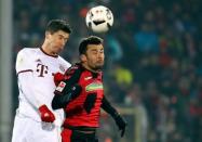 Football Soccer - SC Freiburg v FC Bayern Munich - German Bundesliga - Schwarzwald-Stadion, Freiburg, Germany - 20/01/17 - Freiburg's Manuel Gulde in action with Bayern Munich's Robert Lewandowski during the match. REUTERS/Kai Pfaffenbach