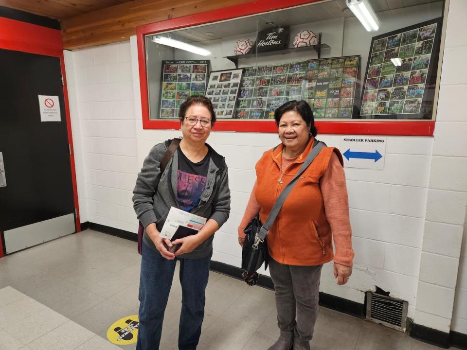 Teresita Barillos, left, and Eugenia Dimabilis smile after voting on Tuesday.