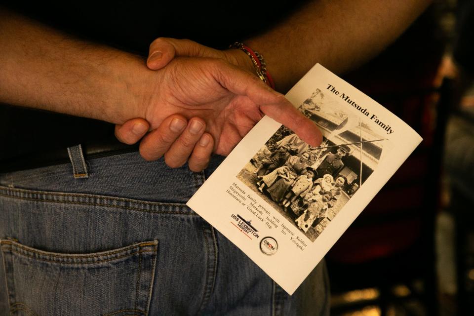 Donald E. Larson, former junior past national president of the Fleet Reserve Association Corpus Christi branch, holds a program of the Japanese "Good Luck" Flag Repatriation Ceremony at the USS Lexington Museum on the Bay Thursday, July 20, 2023.