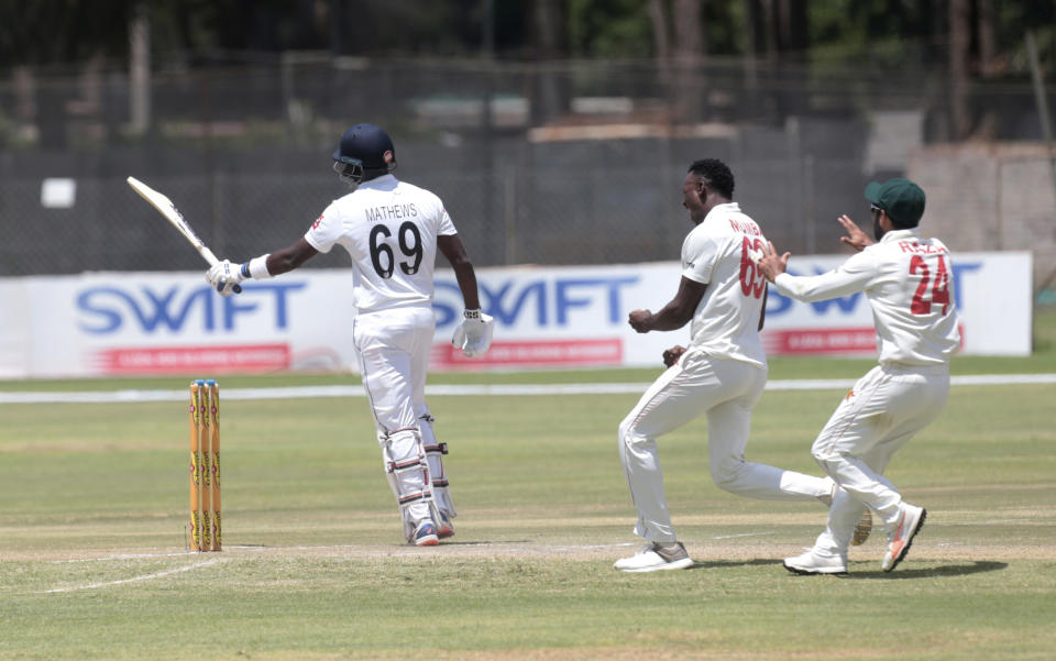 Zimbabwean players celebrate the wicket of Sri Lanka batsman Angelo Mathews, left, during the test cricket match against Sri Lanka at Harare Sports Club, in Harare, Wednesday, Jan. 29, 2020.(AP Photo/Tsvangirayi Mukwazhi)