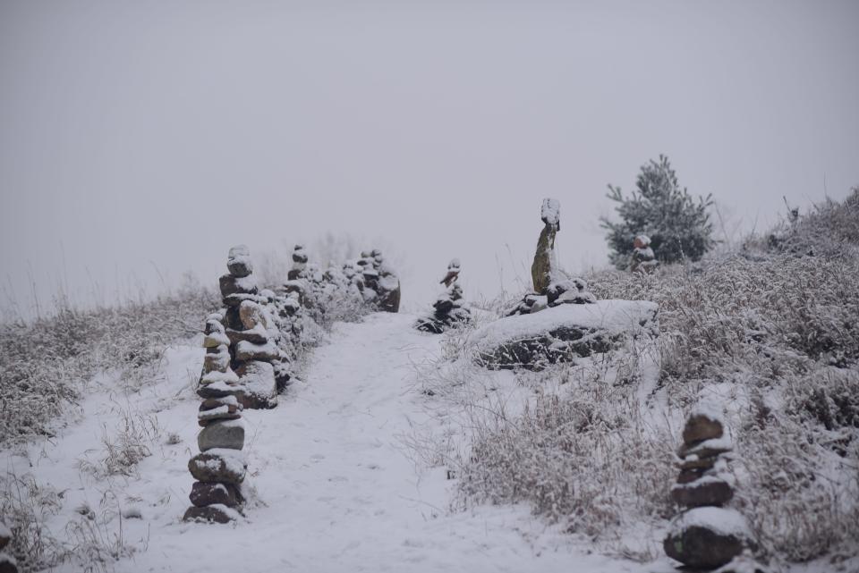 Snow covers the cairns along the path leading up to a small park in the middle of the field at the UVM Wheelock Farm in South Burlington on Tuesday, Dec. 22, 2020