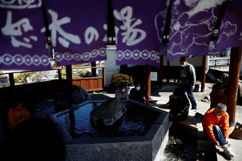 Tourists enjoy a footbath at Kinugawa Onsen, a hot-spring resort, in Nikko