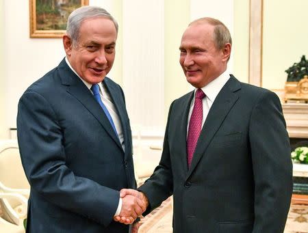 Russian President Vladimir Putin shakes hands with Israeli Prime Minister Benjamin Netanyahu during their meeting at the Kremlin in Moscow, Russia July 11, 2018. Yuri Kadobnov/Pool via REUTERS