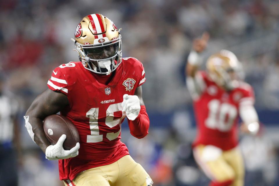 San Francisco 49ers wide receiver Deebo Samuel (19) runs for a touchdown after catching a pass in the third quarter against the Dallas Cowboys in the NFC wild card game at AT&T Stadium.