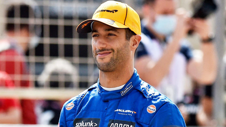 Daniel Ricciardo is pictured standing on the F1 grid.