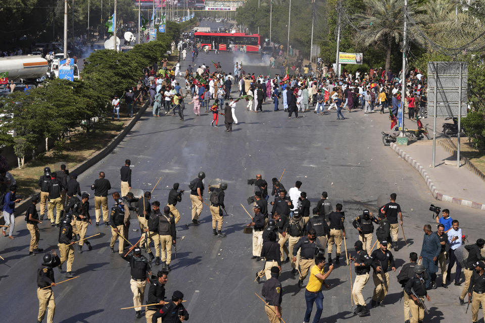 Police officers and supporters of Pakistan's former Prime Minister Imran Khan exchange stones during a protest against the arrest of Khan, in Karachi, Pakistan, Tuesday, May 9, 2023. Khan was arrested Tuesday as he appeared in a court in the country’s capital, Islamabad, to face charges in multiple graft cases. Security agents dragged Khan outside and shoved him into an armored car before whisking him away. (AP Photo/Fareed Khan)