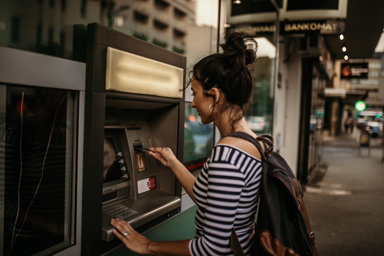 Woman using ATM machine