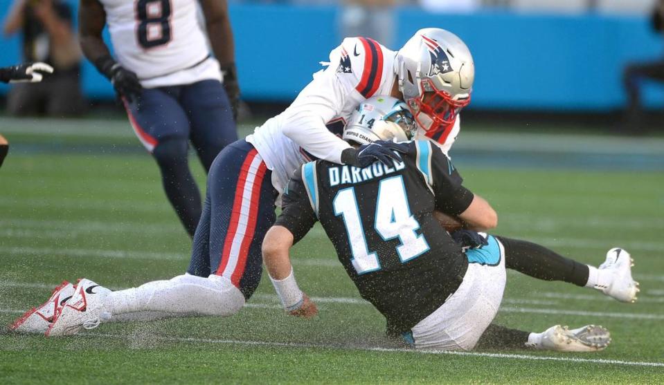 New England Patriots linebacker Kyle Van Noy, left, tackles Carolina Panthers quarterback Sam Darnold on a run during fourth quarter action at Bank of America Stadium in Charlotte, NC on Sunday, November 7, 2021. The New England Patriots defeated the Panthers 24-6.