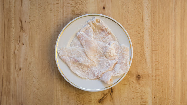 flour-coated flounder fillets on plate