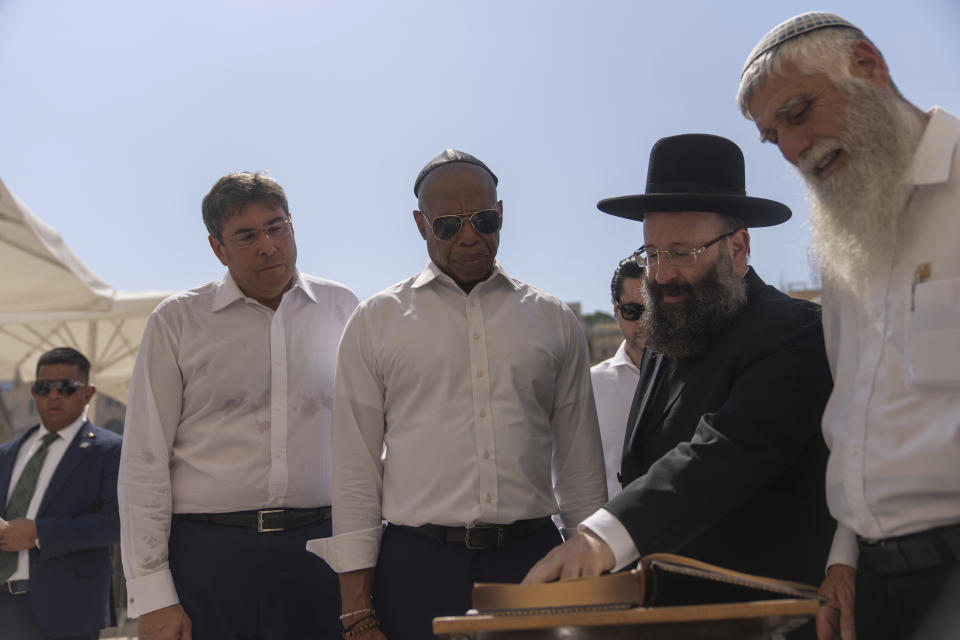 Mayor Eric Adams of New York, center, visits the Western Wall, the holiest spot where Jews can pray, in Jerusalem, Tuesday, Aug. 22, 2023. Adams spent the second day of his visit to Israel touring holy sites before a planned meeting with Prime Minister Benjamin Netanyahu as he sought to avoid publicly weighing into the political crises plaguing the nation. (AP Photo/Ohad Zwigenberg)