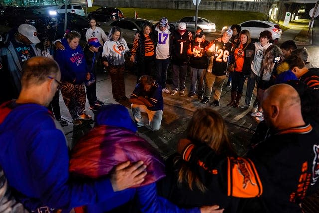 Fans gather outside of University of Cincinnati Medical Center, holding a vigil for Damar Hamlin