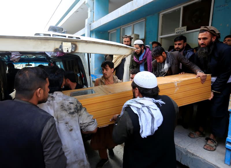 Men carry the coffin of an Afghan victim of an attack on a vehicle carrying Japanese doctor Tetsu Nakamura, in Jalalabad